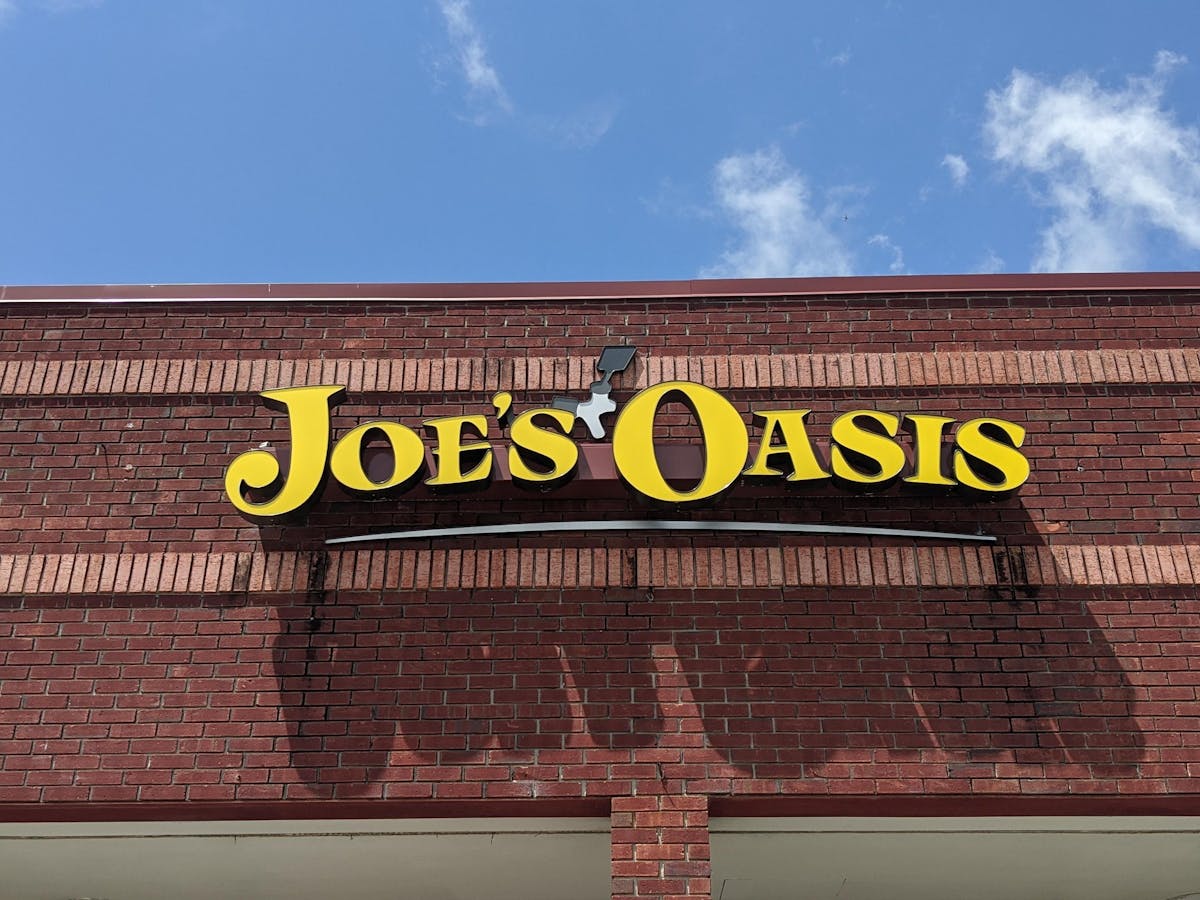 a sign in front of a brick building